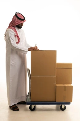 Note-taking and writing, a reliable shipping and delivery process, fast delivery services, ordering and receiving delivery, a portrait of an Arab Saudi Gulf man wearing traditional attire and a ghutrah holding a notebook in his hand working in delivering orders and goods to customers, online shopping and online orders, white background.