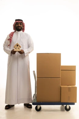 Reliable shipping and delivery process, fast delivery services, ordering and receiving delivery, portrait of an Arab Saudi Gulf man wearing traditional attire and a ghutrah holding a wooden model that works in delivering orders and goods to customers, online shopping and online orders, white background.