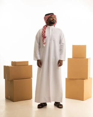 A portrait of a Saudi Arabian Gulf man wearing traditional attire and a ghutrah, transporting boxes of household items, owning a new home and family stability, modern housing and ownership, arranging and organizing the home, cardboard boxes and containers, full-body image, white background.