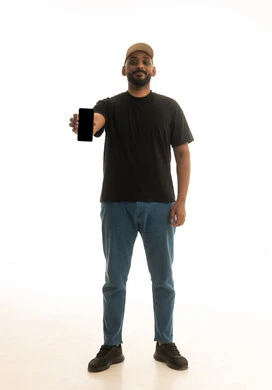 A display of a blank black screen, browsing social media, using modern technological devices, a portrait of a Saudi Arabian Gulf man wearing casual attire using a mobile phone, white background.
