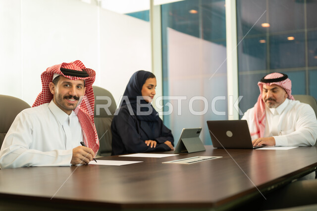 Discussing work plans, providing a comfortable work environment, the concept of team spirit and collective achievement, developing strategies and businesses, success and achieving goals, using modern devices and technologies to accomplish office tasks, Saudi and Gulf Arab employees in a meeting at the company headquarters.