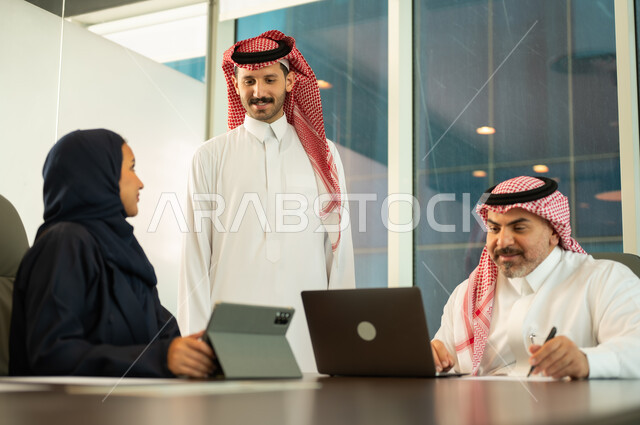 Unity and teamwork, work development and problem solving, holding a meeting for a Saudi Gulf Arab team at the company's headquarters, studying and analyzing new projects, workshops and training, using modern technical equipment, a Saudi office profession and job.