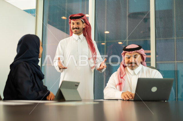 Unity and teamwork, work development and problem solving, holding a meeting for a Saudi Gulf Arab team at the company's headquarters, studying and analyzing new projects, workshops and training, using modern technical equipment, a Saudi office profession and job.