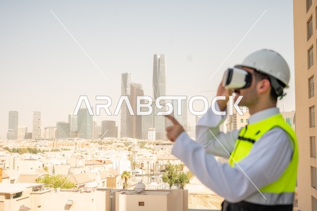 Working in the engineering sector, the growth and development of architecture at the hands of creative sons of the nation, a side view of a Saudi Arabian Gulf engineer wearing traditional clothing, a special jacket and a protective helmet, looking into 3D virtual reality glasses, a background of towers and skyscrapers