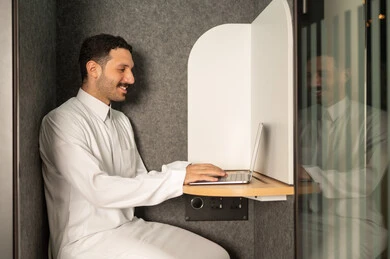 Business administration and organization, use of modern and advanced technical equipment, office administrative profession and job, a Saudi Arabian Gulf man wearing traditional thobe working on a laptop in the office, companies and offices in the Kingdom of Saudi Arabia