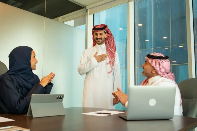 Welcoming new employees, greeting and saluting, using modern technical devices, a Saudi office profession and job, unity and teamwork, developing work and solving problems, holding a meeting for a team of Saudi Gulf Arab employees within the company premises, studying and analyzing new projects, conducting a job interview.