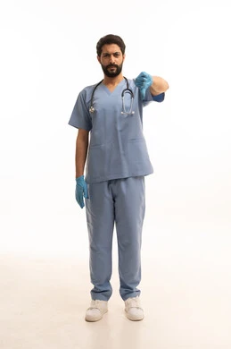 Negative evaluation concept, medicine and healthcare, portrait of a Saudi Arabian Gulf Arab nurse wearing a uniform with a stethoscope providing health services to patients and pointing with a thumbs down, medical profession and job, working in the health sector in the Kingdom, full body, white background