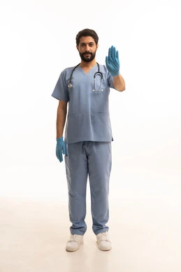 Raising hand with stop gesture, concept of medicine and healthcare, portrait of a Saudi Arabian Gulf nurse wearing uniform with stethoscope providing health services to patients in centers and hospitals, medical profession and job, working in the health sector in the Kingdom, full body, white background