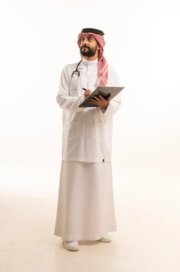 Recording and recording information, concept of medicine and healthcare, portrait of a Saudi Arabian Gulf doctor wearing traditional thobe with coat and stethoscope providing health services to patients in centers and hospitals, medical profession and job, working in the health sector in the Kingdom, full body, white background