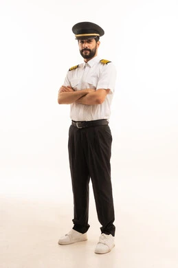 Tourism and travel concept, reception and welcome crew, aviation work, tourist flights, Saudi Airlines, portrait of a smiling Saudi Arabian Gulf Arab pilot wearing the official uniform standing straight with gestures of happiness and pleasure, full body length, white background