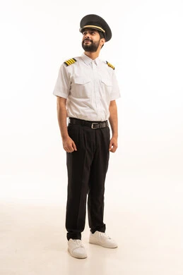 Tourism and travel concept, reception and welcome crew, aviation work, tourist flights, Saudi Airlines, portrait of a smiling Saudi Arabian Gulf Arab pilot wearing the official uniform standing straight with gestures of happiness and pleasure, full body length, white background