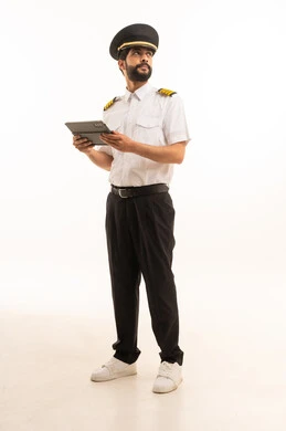 Tourism and travel concept, reception and welcome crew, aviation work, tourist flights, Saudi Airlines, portrait of a smiling Saudi Arabian Gulf Arab pilot in uniform holding a tablet, full body, white background