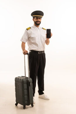Blank black screen view on mobile phone, tourism and travel concept, welcome and reception crew, aviation work, tourist flights, Saudi Airlines, portrait of a Saudi Arabian Gulf Arab pilot in uniform pulling a suitcase, full body, white background