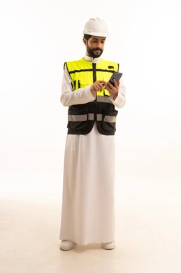 Integrating modern technology and techniques in the field of architecture, interest in urban development by Saudi engineers, national Saudi construction projects, portrait of a Saudi Arabian Gulf engineer wearing a work jacket and a protective helmet, holding a mobile phone, full body, white background
