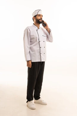 Making a voice call on a mobile phone, portrait of a Saudi Arabian Gulf Arab cook wearing a cooking uniform holding a mobile phone with a happy expression, full body, white background