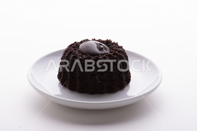 A plate of baked chocolate cake, melted chocolate cream, the most delicious baked sweets.