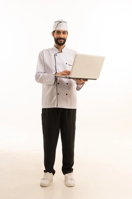 Watch online cooking recipes, professional Saudi cooking profession, portrait of a Saudi Arabian Gulf chef wearing a cooking uniform holding a laptop in his hand, full body, white background