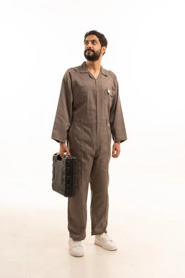 Skill and mastery of work, using maintenance equipment to make repairs, portrait of a Saudi Arabian Gulf man wearing a work uniform holding a tool bag, full body, white background