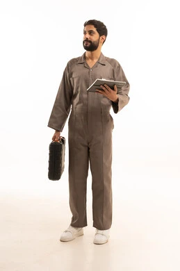 Using modern technical equipment, skill and mastery of work, using maintenance equipment to make repairs. Portrait of a Saudi Arabian Gulf man wearing a work uniform holding a tool bag and a tablet. Full-length body, white background.