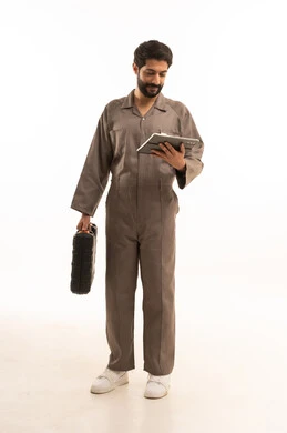 Using modern technical equipment, skill and mastery of work, using maintenance equipment to make repairs. Portrait of a Saudi Arabian Gulf man wearing a work uniform holding a tool bag and a tablet. Full-length body, white background.
