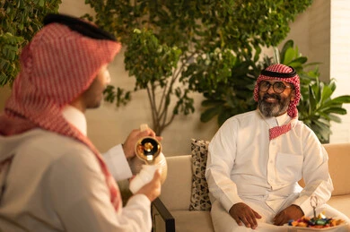 The atmosphere of the Saudi family during Eid, hospitality and reception, and serving hot coffee, the joy and happiness of Eid among family and relatives, Eid customs in Saudi Gulf society, family visits and gatherings during holidays and occasions.