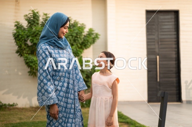 Chalet and recreational resort in the Kingdom, enjoying the summer vacation with the family, gestures of happiness and pleasure, spending a fun and refreshing time in the summer, a family atmosphere full of love, a smiling Saudi Arabian Gulf family walking in the park
