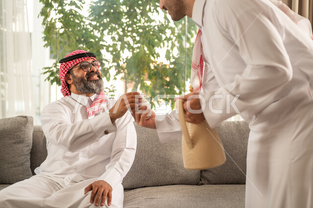 Hospitality, reception, and serving hot coffee, the joy and happiness of Eid among family and relatives, Eid customs in Saudi Gulf society, family visits and gatherings on holidays and occasions, the atmosphere of the Saudi family on Eid