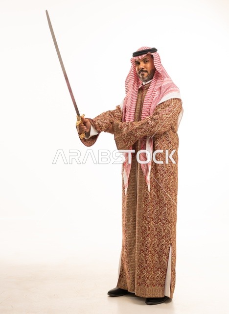 Carrying the sword with pride and honor in celebration of the Day of Bidaya 1727 AD, looking at the camera with gestures of pride, wearing traditional attire for national occasions, a portrait of an Arab Gulf Saudi man wearing the ghutrah and thobe, commemorating the founding of the first Saudi state on February 22, full-body image, white background.