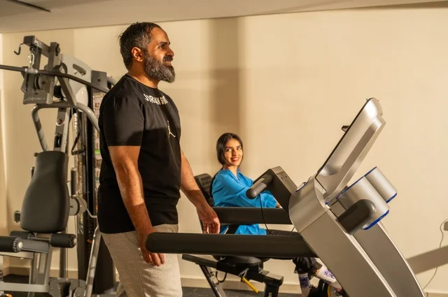 Exercising to maintain fitness, keeping physical fitness and agility, an Arab Gulf man and woman from Saudi Arabia wearing sportswear and doing morning exercise, a healthy lifestyle, spending enjoyable times with family outdoors.