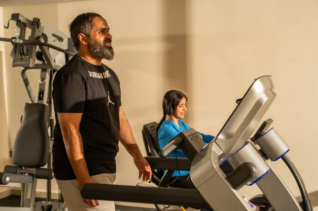 Exercising to maintain fitness, keeping physical fitness and agility, an Arab Gulf man and woman from Saudi Arabia wearing sportswear and doing morning exercise, a healthy lifestyle, spending enjoyable times with family outdoors.