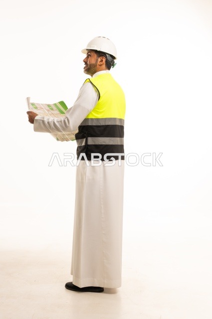 Young engineering job and profession, portrait of a Saudi Arabian Gulf engineer wearing traditional thobe, jacket and protective helmet working in the engineering sector in the Kingdom of Saudi Arabia, engineering project and construction management, concept of planning study and construction project, full body, white background