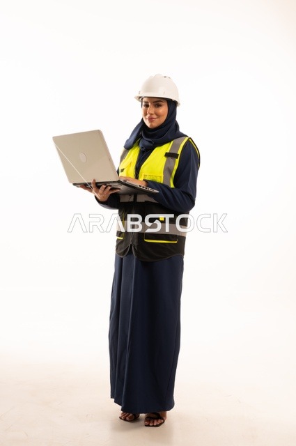 Integrating technology into work, the role of structural engineering in the development of Saudi society, the role of structural engineering in the development of Saudi society, a portrait of a Gulf Arab Saudi Muslim female engineer wearing a white helmet and safety vest working on a mobile device, full-body, white background.