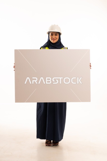 Marketing offers and advertisements, women's professions and jobs in the engineering sector, the role of structural engineering in the development of Saudi society, a portrait of a Muslim Arab Gulf engineer wearing a white helmet and safety vest holding a white board, full-body, white background.