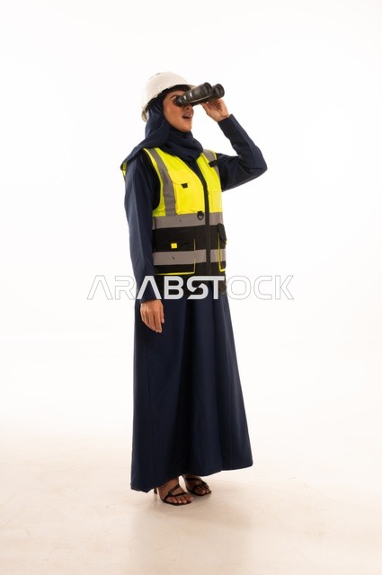 Looking through a telescope at something and standing with a straight back, women's professions and jobs in the engineering sector, the role of structural engineering in the development of Saudi society, a portrait of a Muslim Arab Gulf Saudi female engineer wearing a white helmet and safety vest, full-body, white background.
