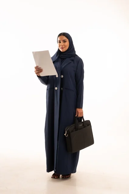 Monitoring daily office tasks and reading notes, a portrait of a smiling Saudi Gulf Arab woman wearing an abaya, carrying a business bag and a white paper, the elegance of Gulf women, attention to external appearance, full-length body, white background.