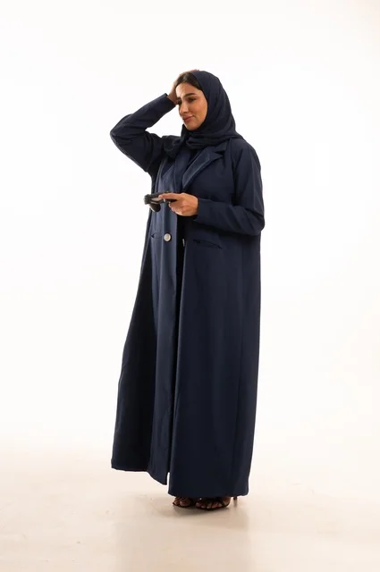 تعابير وجه ويد تدل على الخسارة والحزن، مفهوم الاندماج والتفاعل باللعب ألعاب البلايستيشن، قضاء أوقات ممتعة, بورتريه لشابة عربية خليجية سعودية ترتدي العباءة، سيده سعوديه تمسك بيدها عصا التحكم عن بعد تلعب بألعاب الفيديو، الجسم بالطول الكامل، خلفية بيضاء