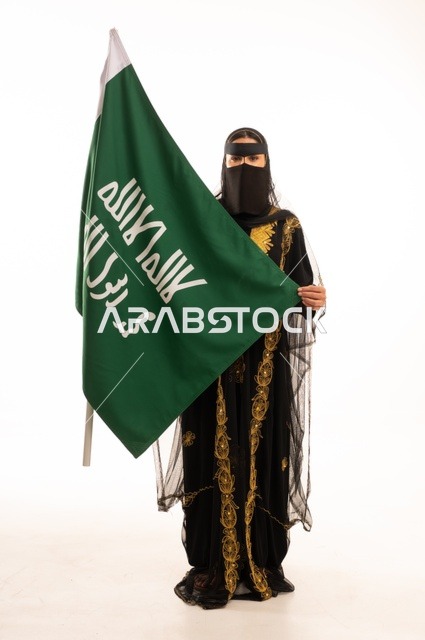 تأسيس الدولة السعودية الأولى 22 فبراير، ذكرى يوم بدينا 1727 م، ارتداء زي المنطقة الوسطى في المناسبات الشعبية والوطنية, بورتريه لإمرأة عربية خليجية سعودية ترتدي البرقع والشيلة تمسك راية وشعار يوم التأسيس بتعابير الفخر والاعتزاز, الجسم بالطول الكامل, خلفية بيضاء