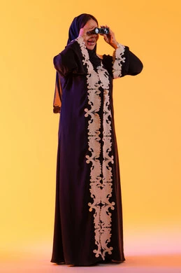 Looking at something, seeing distant things and bringing them closer, a Saudi woman who loves exploration and adventure, a portrait of an Arab Gulf Emirati woman wearing an abaya and hijab, holding a binocular in her hand and looking with gestures of joy and enjoyment.