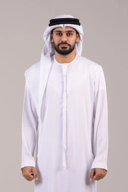 Standing upright and looking at the camera with gestures of self-confidence, the concept of elegance, handsomeness, and attention to external appearance, a portrait of an Emirati Gulf Arab man wearing a kandura and ghutrah, with a white background. Standing upright and looking at the camera with gestures of self-confidence, the concept of elegance, handsomeness, and attention to external appearance, a portrait of an Emirati Gulf Arab man wearing a kandura and ghutrah, with a white background.