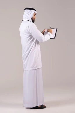 Good interaction with patients, recording test results in the medical record, the concept of medicine and healthcare, working in the health sector, a portrait of an Emirati Arab Gulf doctor wearing a kandura and ghutrah and a medical coat, wearing a stethoscope, writing patient reports, full body length, white background.