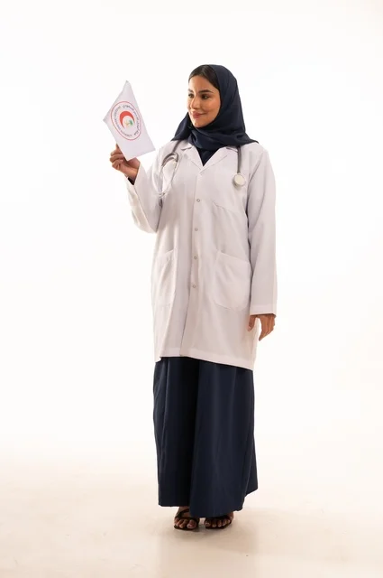 The concept of medicine and healthcare, a portrait of a Saudi Gulf Arab female doctor wearing an abaya and a white coat holding the Red Crescent flag in her hands, a young Saudi woman looking at the camera with expressions of determination and seriousness, marketing promotions and advertisements, white background.