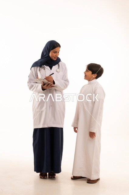 Writing and recording notes for diagnosing the condition, working in the health sector in Saudi Arabia, providing healthcare and caring for patients' health, a portrait of an Arab Gulf Saudi female doctor wearing an abaya and a white coat with a stethoscope, using a stethoscope to listen to heartbeats, focusing on physical health.