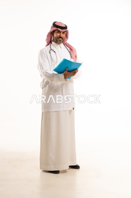 Monitoring patient cases and the necessary recommendations for each patient, a portrait of an Arab Gulf Saudi doctor wearing traditional attire and a white coat holding patient files in his hands, a young Saudi man looking at the camera with expressions of determination and seriousness, white background.