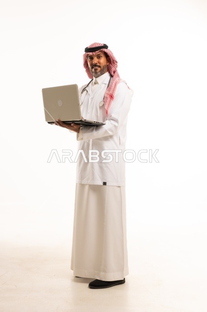 Integrating technology with practical life, paying attention to appearance, providing medical examinations and treatment services, a close-up portrait of a smiling Arab Gulf Saudi doctor wearing a lab coat and stethoscope, holding a mobile phone in his hand to review patient cases, healthcare, white background.