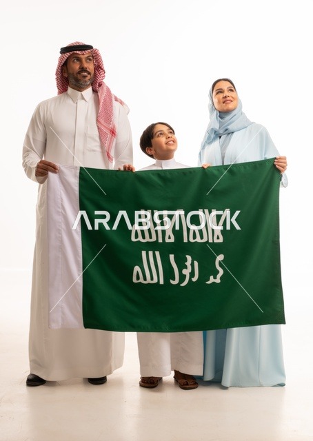 The family atmosphere filled with love, a portrait of a happy Saudi Gulf Arab family holding the flag of the establishment of the Saudi Kingdom on February 22, the celebration of Flag Day on March 11, the Saudi National Day on the 8th of Rabi' al-Awwal, the anniversary of the Saudi National Day, Saudi national holidays and occasions, white background.