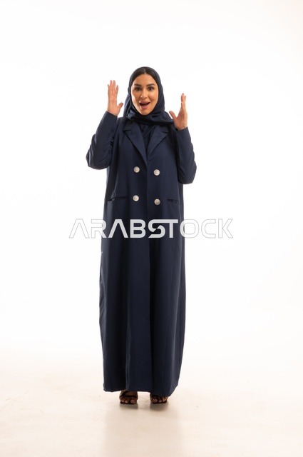 Expressions of hands showing astonishment and surprise, attention to appearance and elegance, expressions of amazement, a portrait of a veiled Arab Gulf Saudi woman wearing an abaya, a young Saudi woman, the concept of expression through gesture, full-body image, white background.