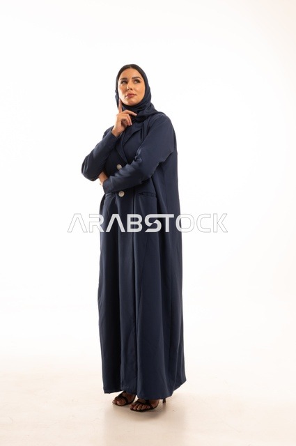 Hand expressions on the forehead indicate contemplation and deep thinking, concern for appearance and elegance, expressions of wishing and smiling, a portrait of a Saudi Arabian Gulf woman wearing a hijab and an abaya, a young Saudi woman, the concept of expression through gesture, full-body image, white background.