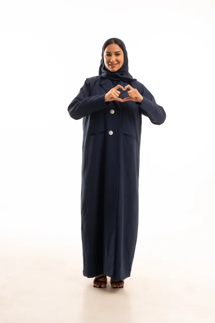 Hand gesture forming a heart shape to send love, attention to appearance and elegance, expressions of joy and a smile, a portrait of a Saudi Arabian Gulf woman wearing a hijab and an abaya, a young Saudi woman, the concept of expression through gesture, full-body image, white background.
