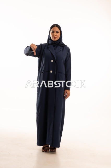 A gesture using the thumb pointing down, expressions of sadness, concern for appearance and elegance, expressions of displeasure and regret, a portrait of a Saudi Arabian Gulf woman wearing a hijab and an abaya, a young Saudi woman, full-body image, white background.