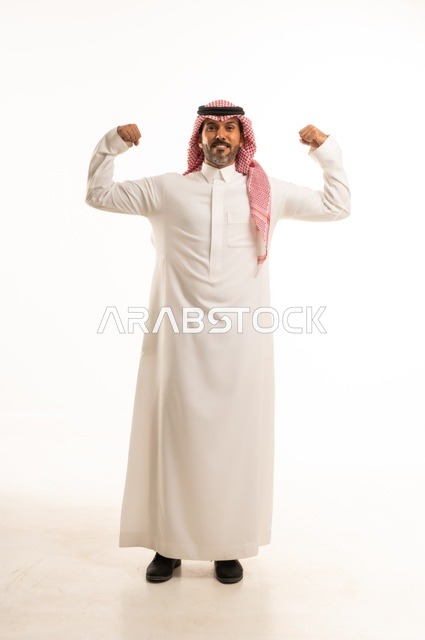 Increasing muscle endurance, mastering boxing techniques, a portrait of an Arab Gulf Saudi man wearing traditional attire raising his fists in gestures of strength, looking at the camera with expressions of self-confidence, practicing martial arts, full-body shot, white background.
